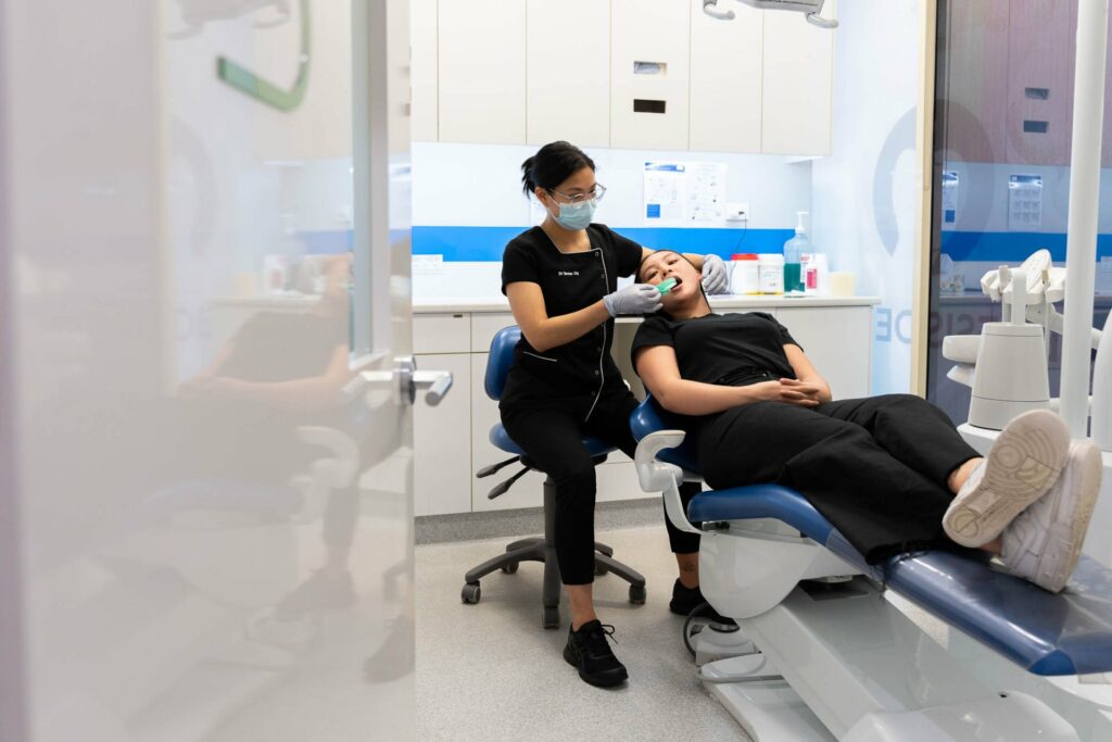 Dentist providing patient with dental check up and clean