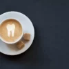 Coffee with a tooth drawn as latte art suggesting it will affect teeth whitening longevity