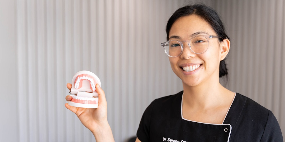 Dr. Serene Ong showing how to clean dentures