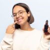 Young woman pointing at her teeth wondering "is vaping bad for your teeth?"