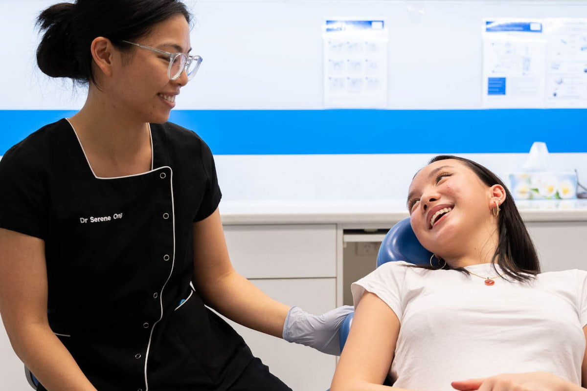 Dentist consulting patient on their teeth aligners