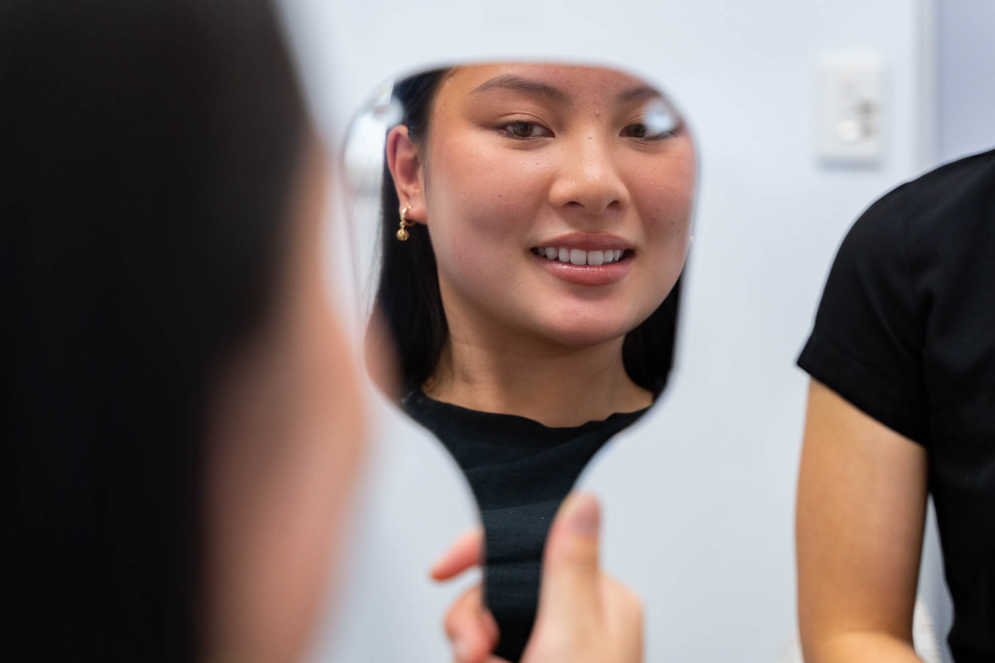 Patient inspecting their veneers in Canning Vale