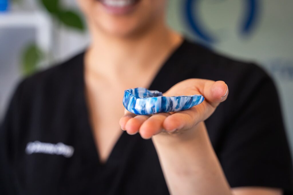 Dr Serene holding a custom mouthguard perth