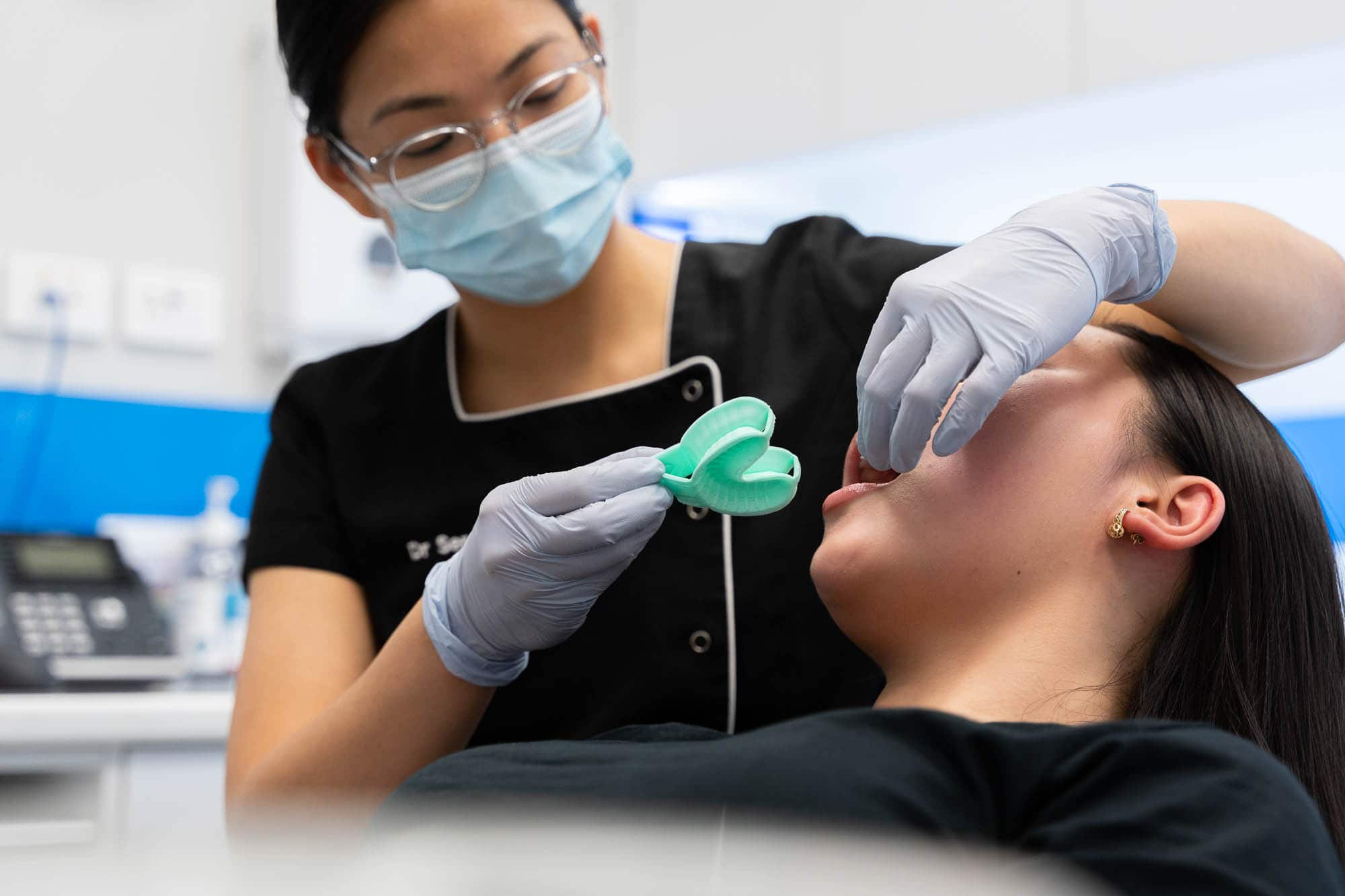 Dentist doing mouth mould for teeth grinding